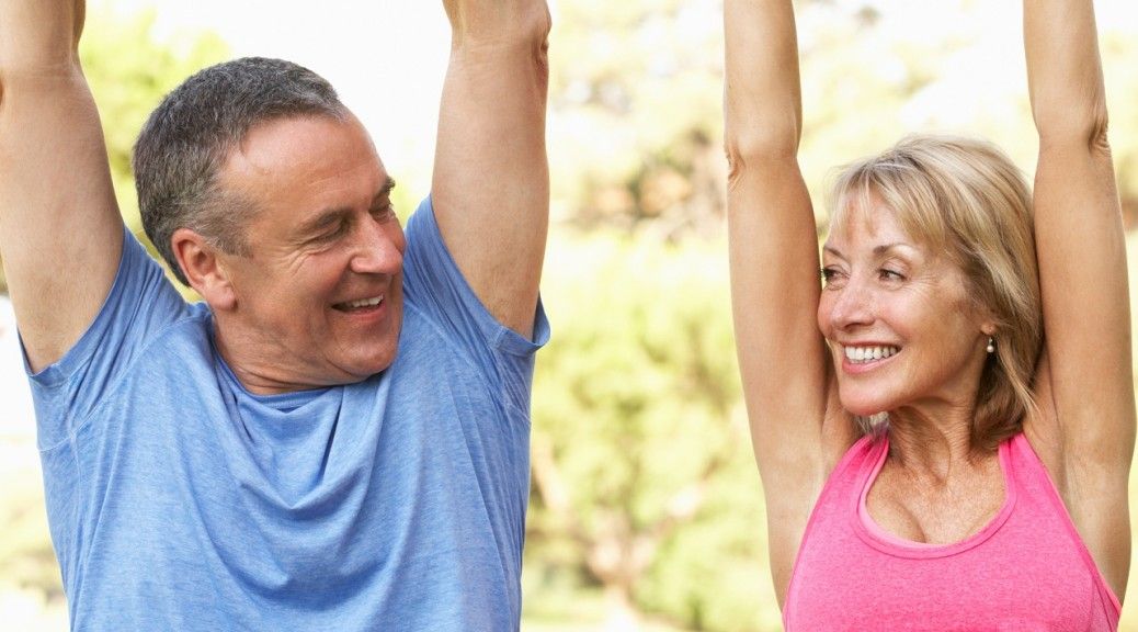 Senior Couple Exercising In Park