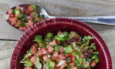 Bowl and spoon filled with watermelon salsa