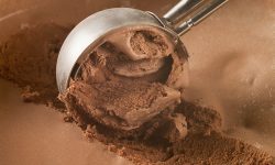 Ice cream scoop scooping up dairy-free chocolate ice cream